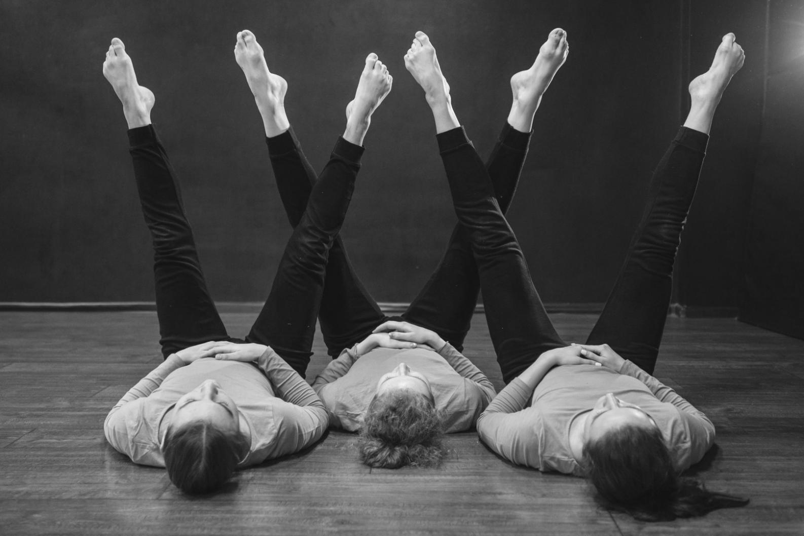 Coppia di ballerini in elegante posizione di danza, illuminati da luce soffusa